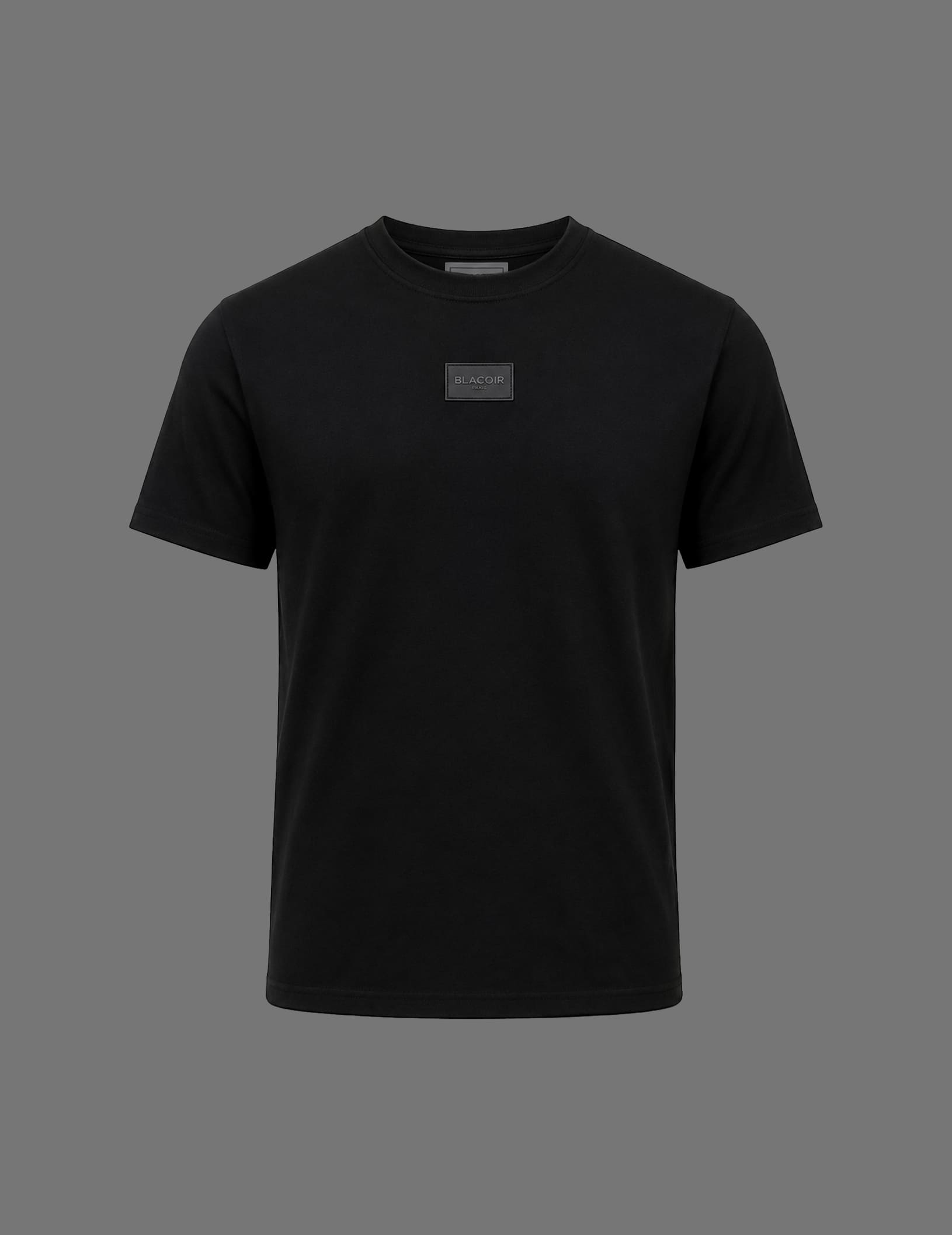 Premium black BLACOIR crew neck t-shirt featuring a tonal BLACOIR Paris chest patch, relaxed fit, short sleeves, and minimalist luxury design on a neutral grey background.