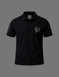 Premium black BLACOIR polo shirt featuring a tonal panther emblem on the chest, contrast number detail on the sleeve, classic collar, and short sleeves displayed on a neutral grey background.
