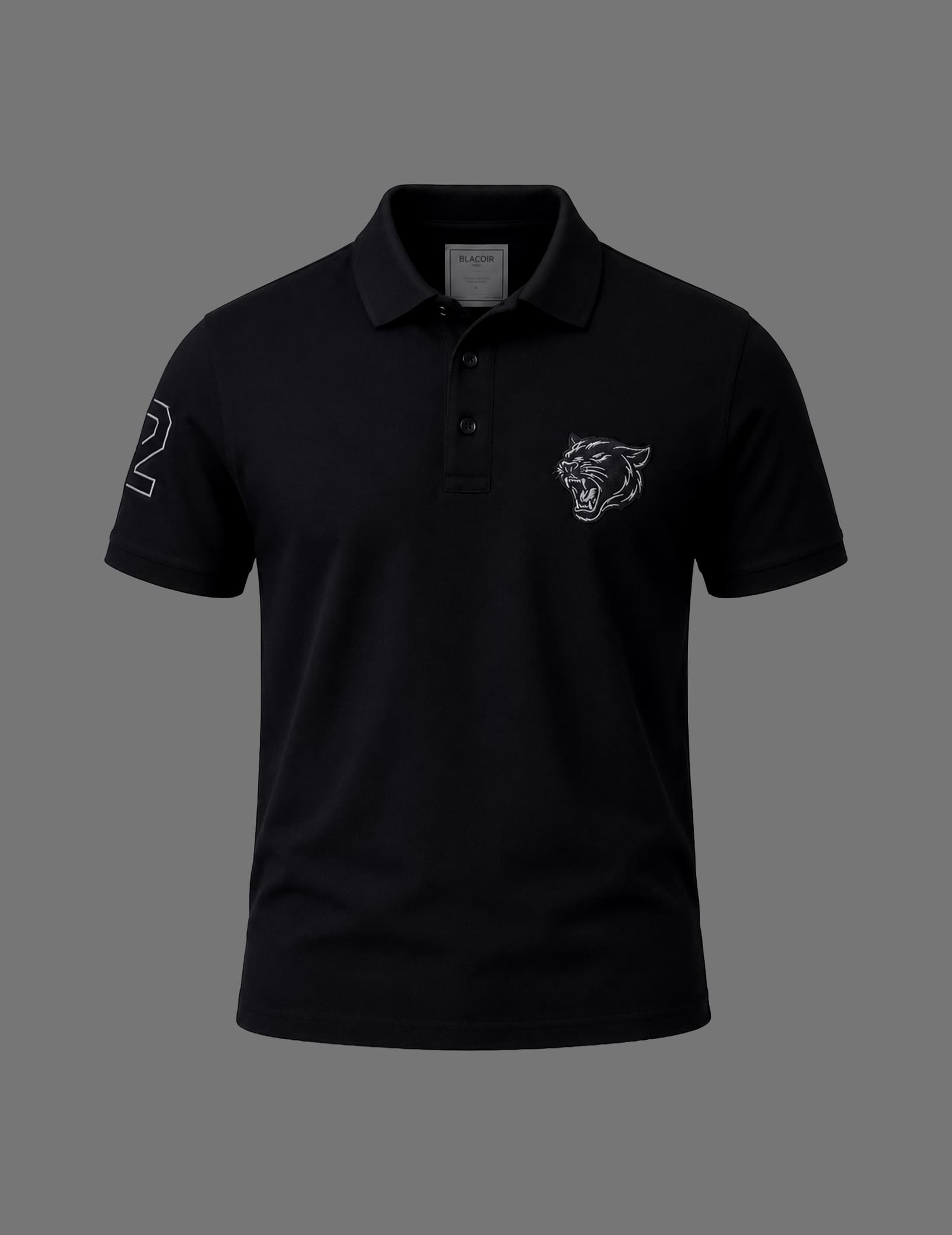 Premium black BLACOIR polo shirt featuring a tonal panther emblem on the chest, contrast number detail on the sleeve, classic collar, and short sleeves displayed on a neutral grey background.