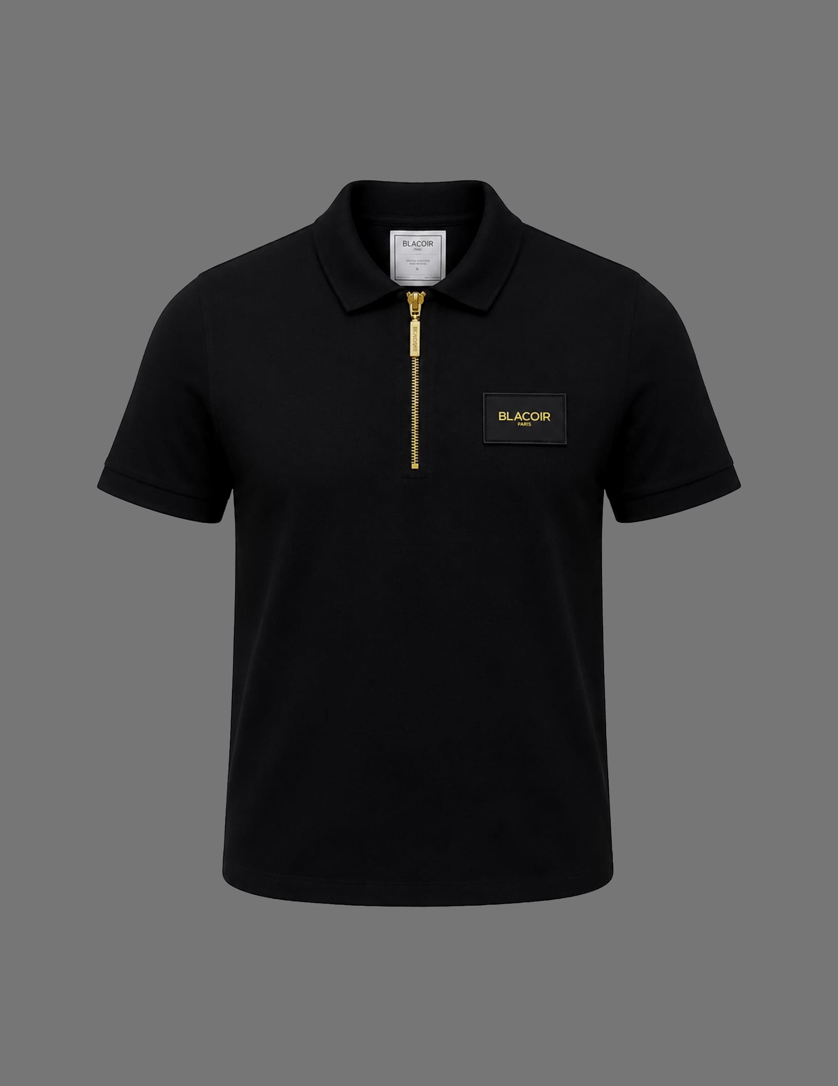Premium black BLACOIR Paris zip polo shirt featuring a gold quarter-zip closure, structured collar, short sleeves, and luxury chest logo patch on a neutral grey background.