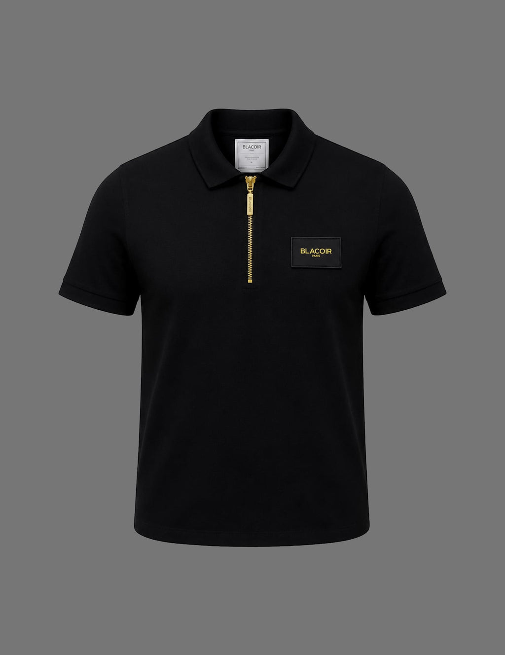 Premium black BLACOIR Paris zip polo shirt featuring a gold quarter-zip closure, structured collar, short sleeves, and luxury chest logo patch on a neutral grey background.