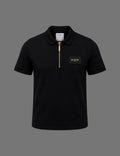 Premium black BLACOIR Paris zip polo shirt featuring a gold quarter-zip closure, structured collar, short sleeves, and luxury chest logo patch on a neutral grey background.